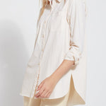 color=Eggnog, angled front view, stretch microfiber women's button up shirt with patch pockets and roll-tab sleeves